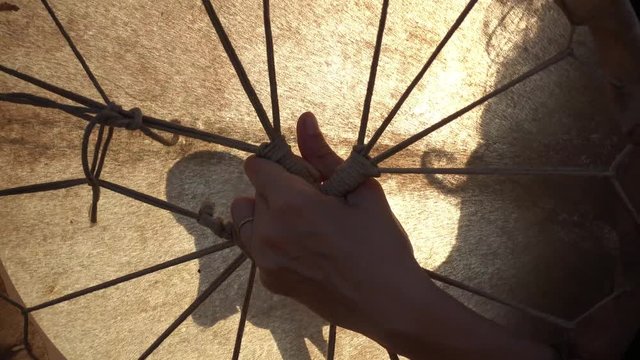 Close up of a percussionist playing an ancient shamanic drum