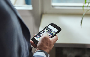 Male hand holding mobile smart phone