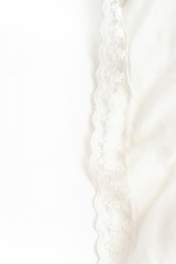 White soft wrinkle thin fabric blanket texture background, wallpaper, backdrop. Space for text.