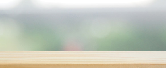 wood plank table top on blur abstract green tree and leaves ,See view the gardening behind for...