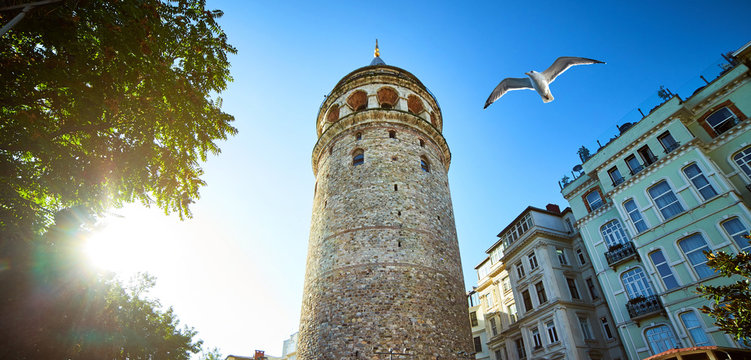 Galata Kulesi Tower and street in the old city of Istanbul, Turkey. Ancient Turkish famous landmark in Beyoglu district, European side. Architecture of the former Constantinople. - Powered by Adobe