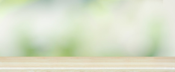 wood table top on blur abstract green tree in the gardening for banner and  background or display...