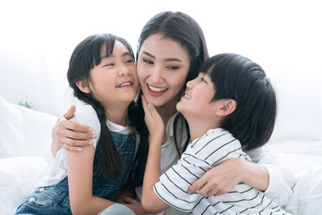 Obraz premium Asian family, Spending time together in the family, Boys and girls embrace their mothers with happiness.