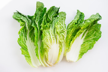 fresh green chinese cabbage leaves on white background