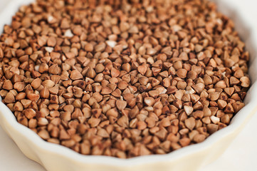 A small plate of buckwheat - traditional Russian meal - on white