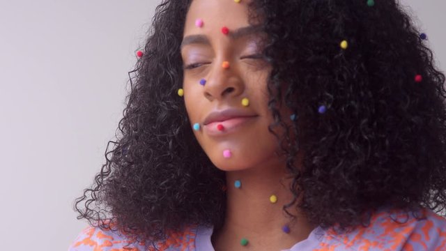 closeup portrait a mixed race black woman with creative makeup in studio