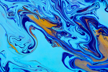 Fluid art texture. Abstract backdrop with swirling paint effect. Liquid acrylic artwork with trendy mixed paints. Can be used for website background. Blue, golden and cyan overflowing colors
