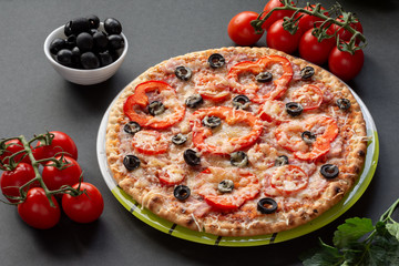 Pizza with olives, tomatoes, ham. Still-life. Assorted pizza