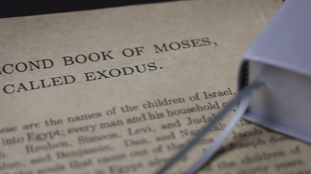 A piece of paper with the text of the first chapter of the Bible book of Exodus. focus moves to lines mentioning the celebration of Easter.