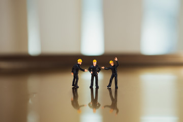 Miniature people, engineer team standing action using as industrial concept