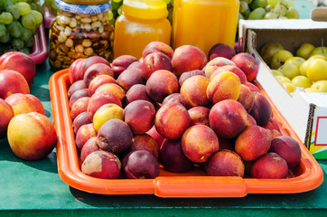 juicy nectarines on a tray in the market