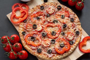 Pizza with olives, tomatoes, ham. Still-life. Assorted pizza