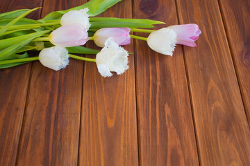 Pink tulips on the wooden background. Flat lay, top view. Valentines background.