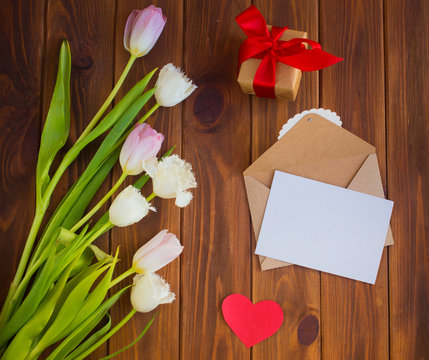 Pink tulips on the wooden background. Flat lay, top view. Valentines background.