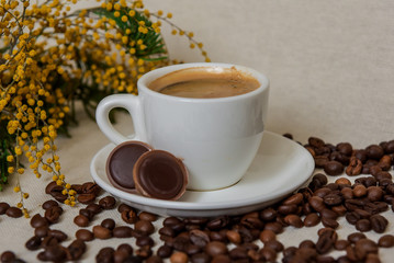A cup of fresh espresso with chocolates. Coffee beans. Morning coffee concept