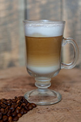 Cappuccino in a glass mug. Beautiful coffee with foam. Latte