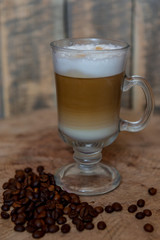 Cappuccino in a glass mug. Beautiful coffee with foam. Latte