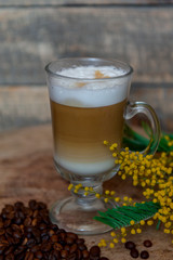 Cappuccino in a glass mug. Beautiful coffee with foam. Latte