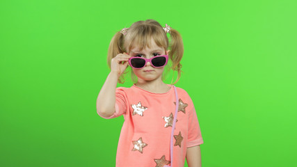 Positive girl in pink blouse and sunglasses posing and make faces. Chroma Key