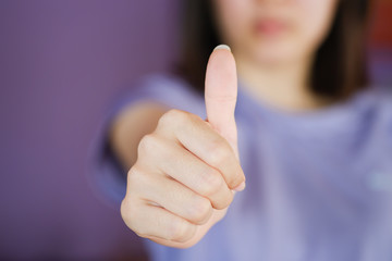 Woman shows thumbs up. good hand, good job, for agreement sign with success concept. closeup shot.