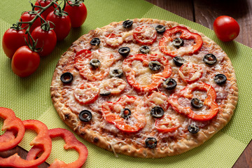 Pizza with olives, tomatoes, ham. Still-life. Assorted pizza