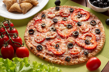 Pizza with olives, tomatoes, ham. Still-life. Assorted pizza