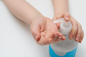 Child using pump bottle antibacterial gel close up