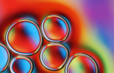 Water drops in oil macro abstract with multicolor reflections