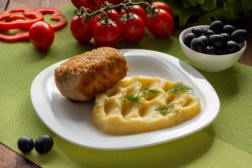 Cutlet in Kiev. Cutlets in breadcrumbs, stuffed with butter and herbs, served with potatoes. Still-life