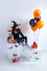 A girl in a little witch costume for Halloween.
