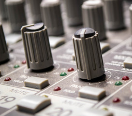 Music mixer in studio closeup. Shot of rotary switch and jack connector in audio board concerte...