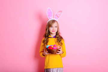 Obraz na płótnie Canvas Happy Easter! Little girl having fun to paint Easter eggs.