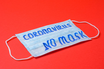 inscription coronavirus on mask, inscription no masks on red background.
