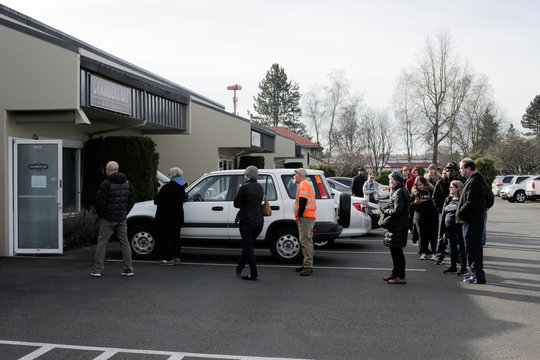 People wait in line for hands sanitizer for free at Chambers Bay Distillery, which is creating the product with ethanol alcohol and giving it away, following reports of coronavirus disease (COVID-19) cases in the country, in University Place