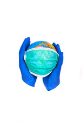 Coronavirus. Covid 19. Earth with mask, blue gloves and stethoscope on the white background. 