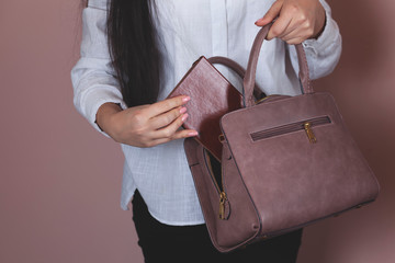 woman hand holding notepad with bag