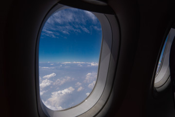 Fototapeta na wymiar Plane window, external view and clouds