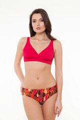 Fototapeta premium beautiful girl posing in stylish detailed coral bikini on white background.