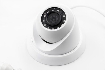 Dome secure camera on light background with motion sensors. Video surveillance camera. Closeup, selective focus