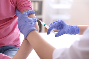 Little girl receiving chickenpox vaccination in clinic, closeup. Varicella virus prevention