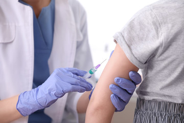 Little girl receiving chickenpox vaccination in clinic, closeup. Varicella virus prevention