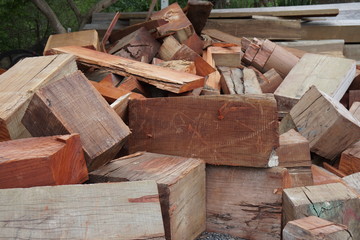 A pile of chopped firewood logs ready for the winter. Heating season, winter season. Cut logs fire wood. Hardwood, wood and lumber industry. Renewable resource of energy. Environmental concept.