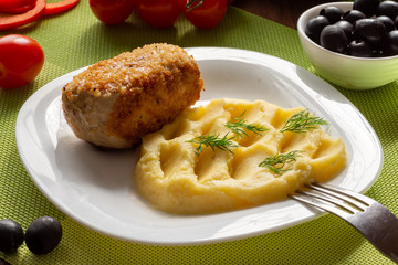 Cutlet in Kiev. Cutlets in breadcrumbs, stuffed with butter and herbs, served with potatoes. Still-life