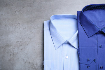Stylish shirts on grey background, flat lay. Dry-cleaning service