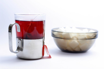 Cup of tea with a small bowl of sugar cubes