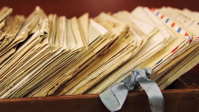 Old postal letters in a wooden box
