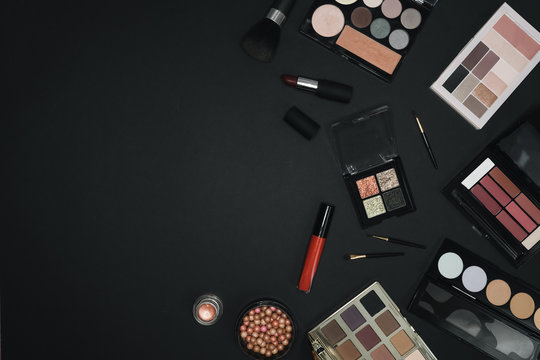 Many professional cosmetics for make up on black background 