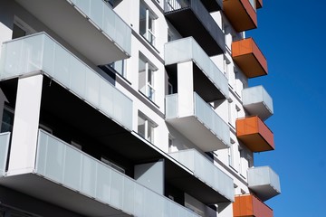 Fototapeta premium Modern apartment buildings on a sunny day with a blue sky. Facade of a modern apartment building