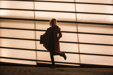 Silhouette of a young girl dancing in the city