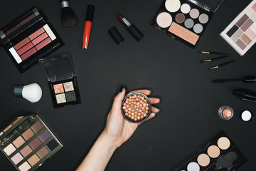 Many professional cosmetics for make up on black background 